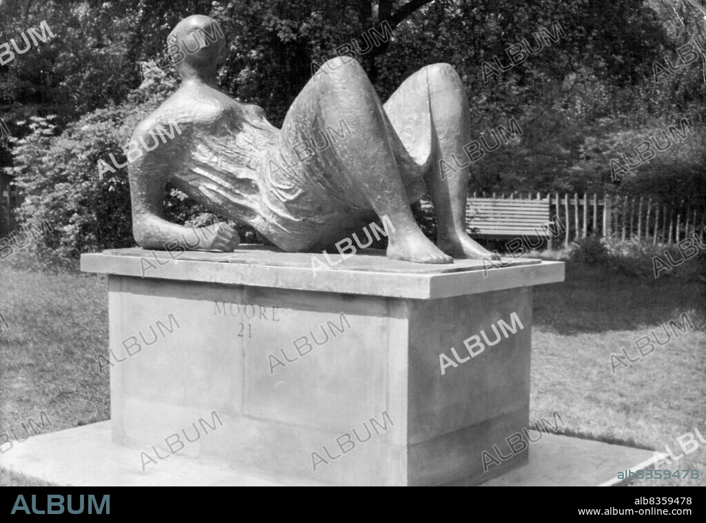 Sculpture In The Open Air -- Henry Moore's "Draped Reclining Figure" in bronze is seen in the London Country-Council Third International Exhibition of Sculpture which opens in Holland Park, London, May 28th. May 27, 1954. (Photo by Associated Press Photo).