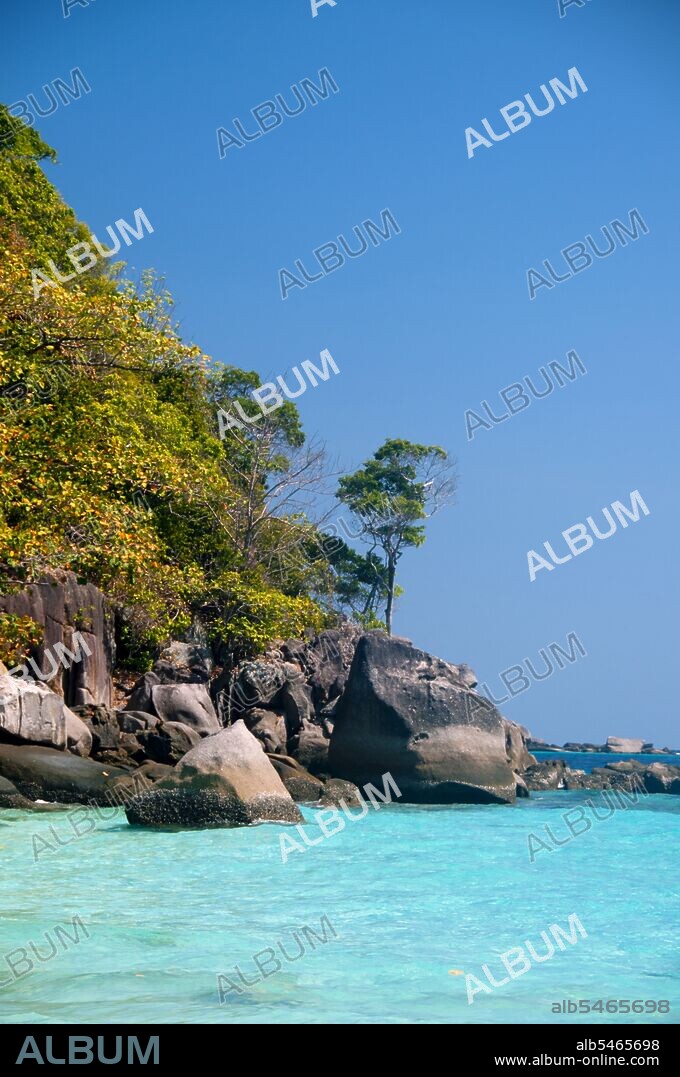 The Similan Islands lie approximately 100 kilometres northwest of Phuket in the Andaman Sea. In 1982, this 128 square kilometre area was declared a marine national park, and in recent years the group of nine small islands (Similan is derived from the Malay sembilan, and means nine) has become one of the leading attractions for visitors to southern Thailand. The islands are renowned among divers for their rich coral reefs, clear waters and pristine beaches. The best diving months are between December and May when the weather is fine and underwater visibility at its best. The Similans offer over 200 species of hard coral, many more soft corals, hundreds of colourful fish species, and tens of thousands of other marine organisms which make their homes on the reefs.