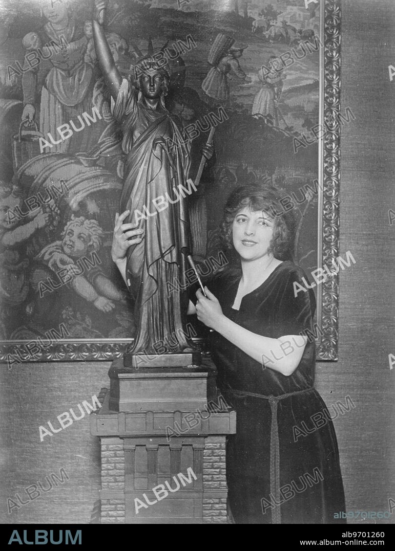 Most beautiful girl in the Golden West , a sculptress of great ability . Miss Beryl Halley ( 19 ) who has just returned to New York from California , where she has been appearing on the films . Besides being declared the beautiful girl in the Golden West , she is a sculptress of no little ability . She is seen with her latest model of the " Goddess of Liberty " . 23 December 1922.