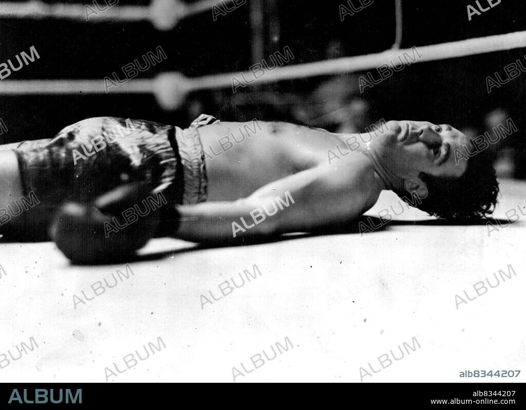 Doyle Knocked Out In The First Round -- Jack Doyle on his back in the centre of the ring after being knocked out in the first round.
Eddie Phillips, the Bow (London) heavyweight, knocked out Jack Doyle, the Irish heavyweight, in the first round of their return match at the White City, London to-night They fought last September,when Phillips was the winner Doyle being counted out in the second round after falling out of the ring.
The "horizontal heavyweight." Eddie Phillips knocked Doyle out in the first round of their fight at the White City. At their previous meeting Phillips won in the second round. July 10, 1939. (Photo by Topical Press).