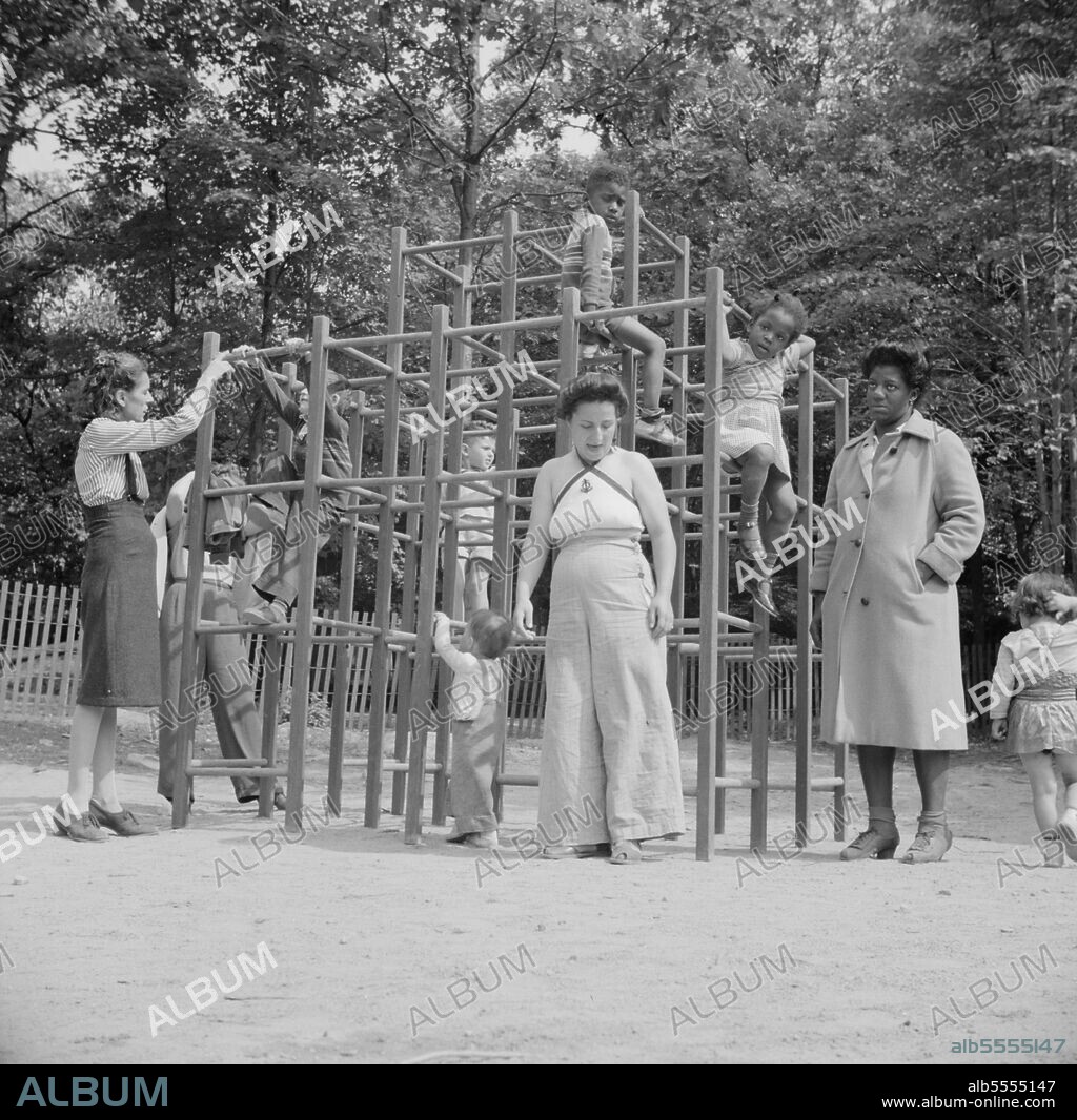 GORDON PARKS. Arden, New York. Interracial activities at Camp Ellen Marvin, where children are aided by the Methodist Camp Service. Mothers supervising their children who are playing in a jungle gym.