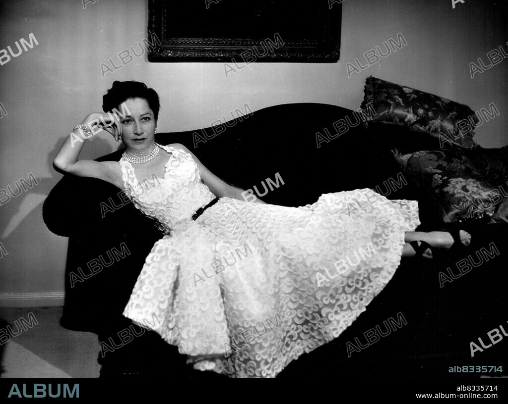 Mrs. Helen Parnell -- Wife of Mr. Val Parnell, the theatrical impresario and producer. In this portrait study she is wearing a lace gown created by Hardy Amies. July 29, 1953. (Photo by Baron, Camera Press).
