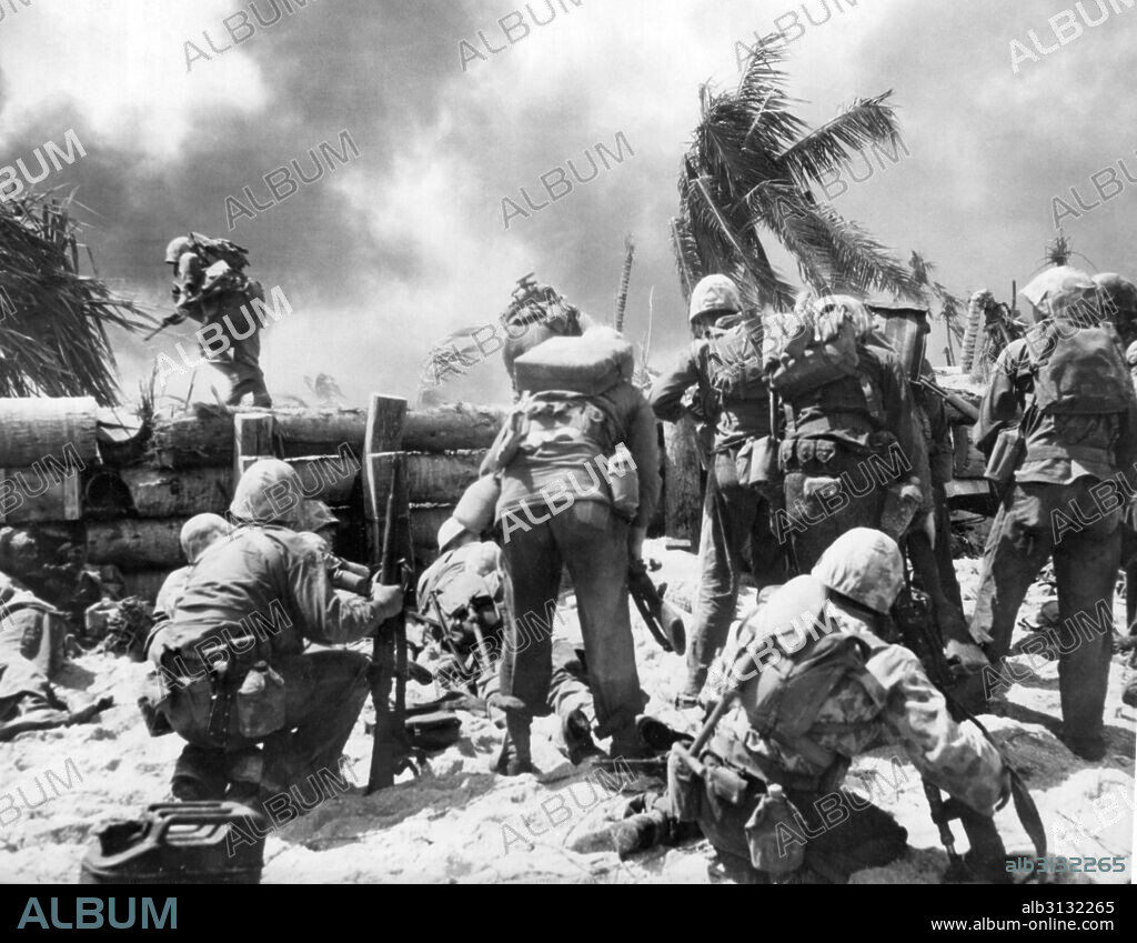 Gilbert Islands, Pacific Ocean:  November, 1943 Two U. S. Marines go over the Japanese wall fortification during the battle for the Japanese held island of Tarawa.