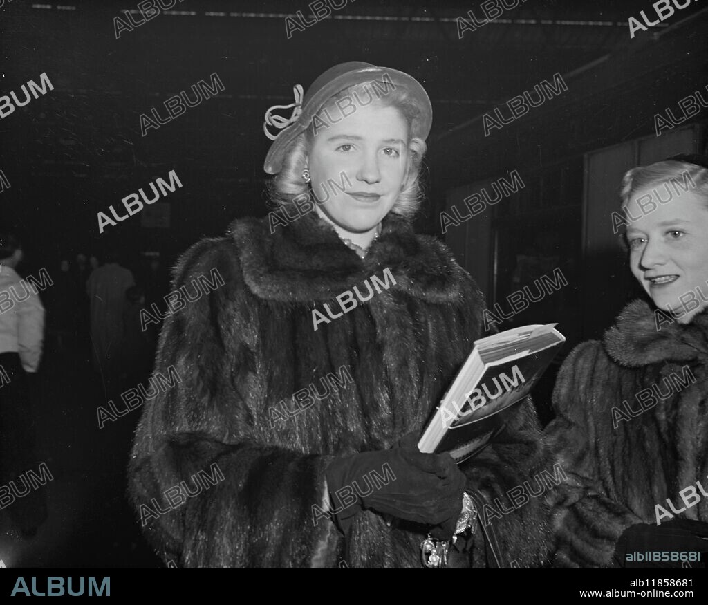 SHARMAN GOES HONME. MISS SHARMAN DOUGLAS , daughter of Lewis Douglas , former popular American Ambassador in London , shown here as she is about to board the ' Queen Elizabeth boat train for America at Waterloo Station , London . 16 December 1950.