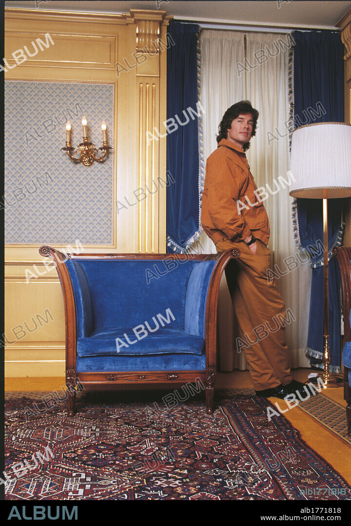 Ronn Moss leaning on an armchair. American actor Ronn Moss leaning on the armchair. 1990s.