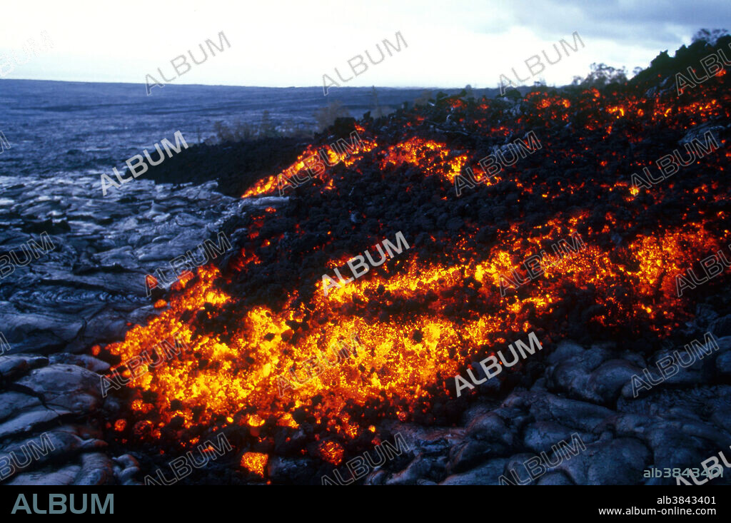 Pahoehoe lava (meaning smooth, unbroken lava, a basaltic lava with a smooth, billowing, undulating or ropy surface, due to the movement of very fluid lava under a congealing surface crust) from Hawaii's Kilauea volcano.