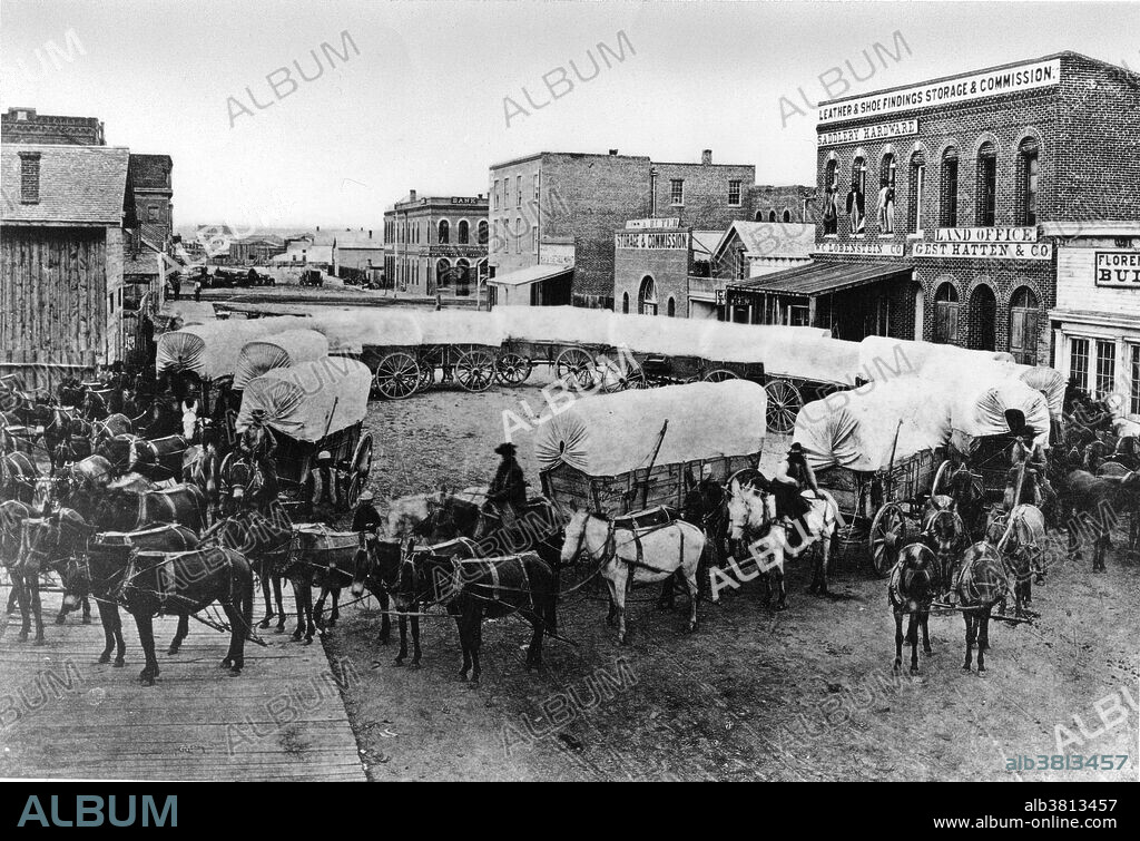 A wagon train on the streets of Denver circa 1860. Manifest Destiny was the 19th and 20th century American belief that the United States was destined to expand across the North American continent. The Homestead Act of 1862 encouraged 600,000 families to settle the West by giving them land (usually 160 acres) almost free. They had to live on and improve the land for five years. Helping settlers move westward were the emigrant "guide books" of the 1840s featuring route information supplied by the fur traders and the FrÃ©mont expeditions, and promising fertile farm land beyond the Rockies.