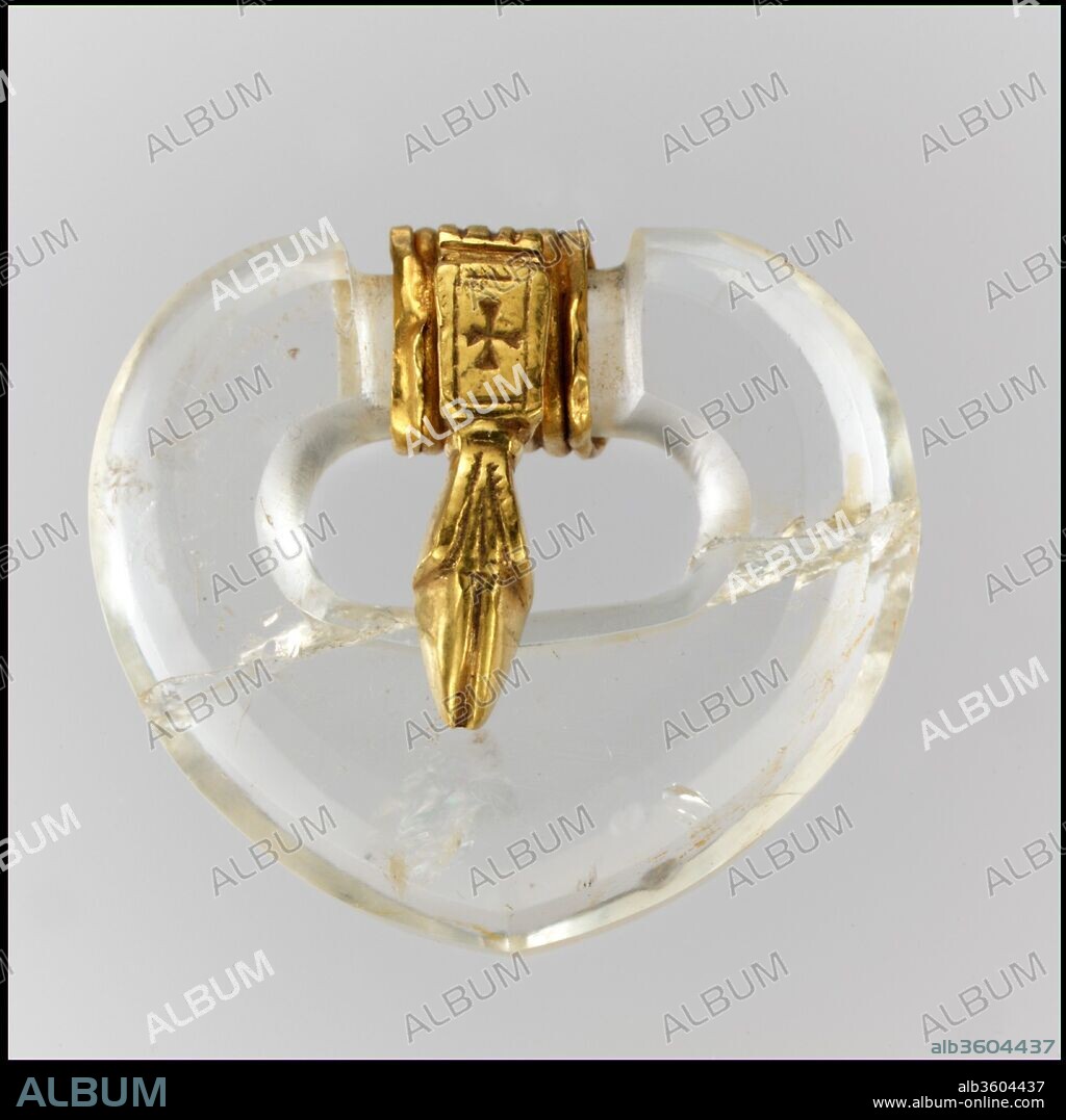 Rock Crystal Belt Buckle. Culture: East German (buckle), Byzantine (tongue). Dimensions: Overall: 1 3/4 x 1 9/16 x 11/16 in. (4.5 x 4 x 1.8 cm). Date: ca. 500 (buckle), 500-600 (tongue).
It is impossible to know precisely when the delicate gold tongue was added to the buckle, but the ensemble conveys the ease with which Byzantine and Germanic styles were combined.