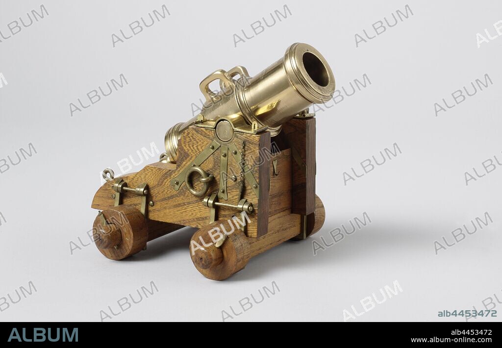 Model of a 16-Pounder Stone Howitzer on a Ship's Carriage, Model of a howitzer on a horse. The howitzer is 19.6 cm long and has a caliber of 33 mm. The inscriptions are engraved on the barrel, along with crossed anchors and palm branches. The barrel has two ears. The very short rolled horse consists of two parallel cheeks with two steps connected by a vertical calf, a crossbar and the ashes, the soleplate lies on the ashes. The target block can be slid back and forth on the soleplate and fixed in different positions by means of pins in an edge on the inside of the cheeks. The ash struts are attached to the cheeks with brackets that can be removed. The double wooden wheels are all of the same dimensions. Scale 1: 6 (scale on model)., anonymous, Rotterdam (possibly), 1800, wood (plant material), brass (alloy), h 18 cm × w 23 cm × d 19 cm × c 33 mm × w 3.6 kg.