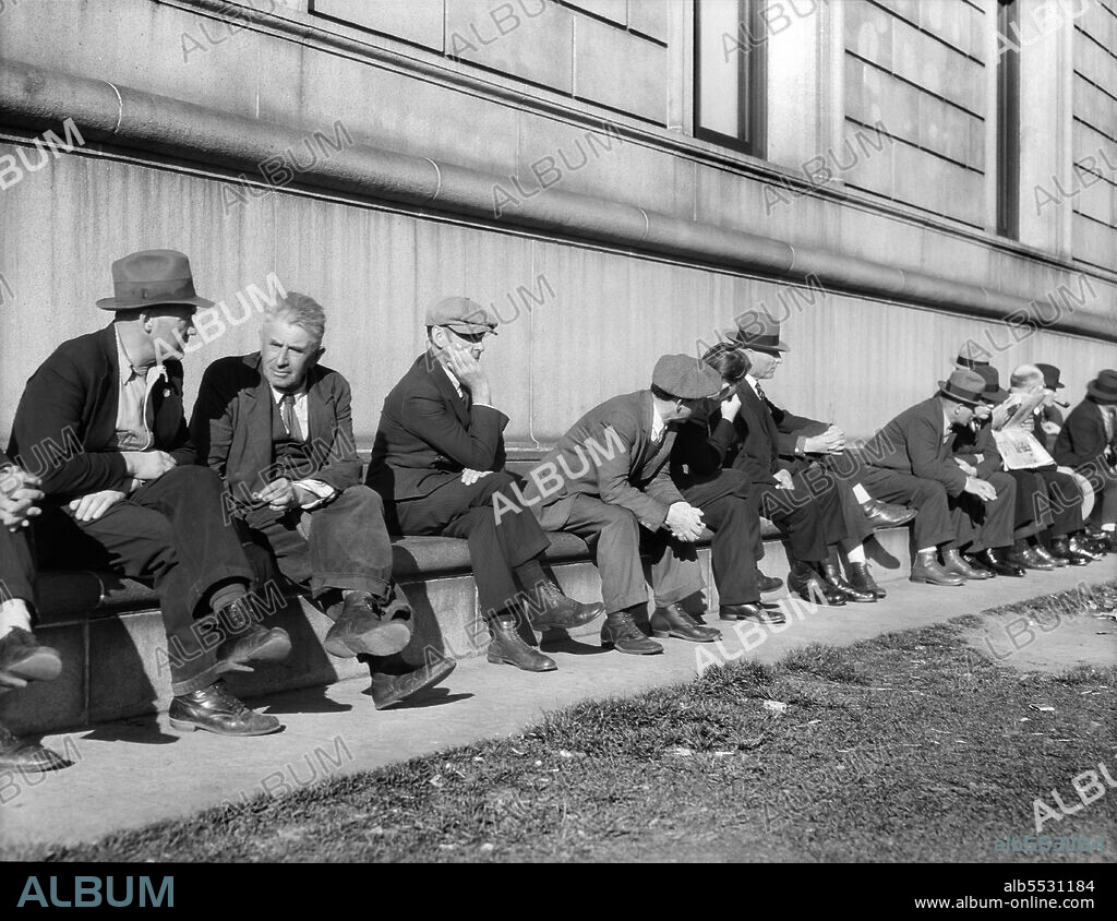 Group of Unemployed Men sitting on side of Public Library, San Francisco, California, USA, Dorothea Lange, U.S. Office of War Information/U.S. Farm Security Administration, February 1937.