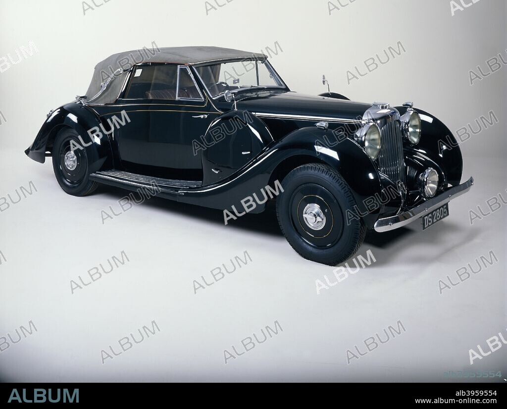 A 1939 Lagonda V12 cabriolet. The Company was started by an American, Wilbur Gunn. He came to England in 1891, and eventually started to build motorcycles in 1898 working from the greenhouse of his home at Staines, around which the factory eventually grew. The name Lagonda was the Shawnee Indian name for what is now Buck Creek in Gunn's native Springfield, Ohio.