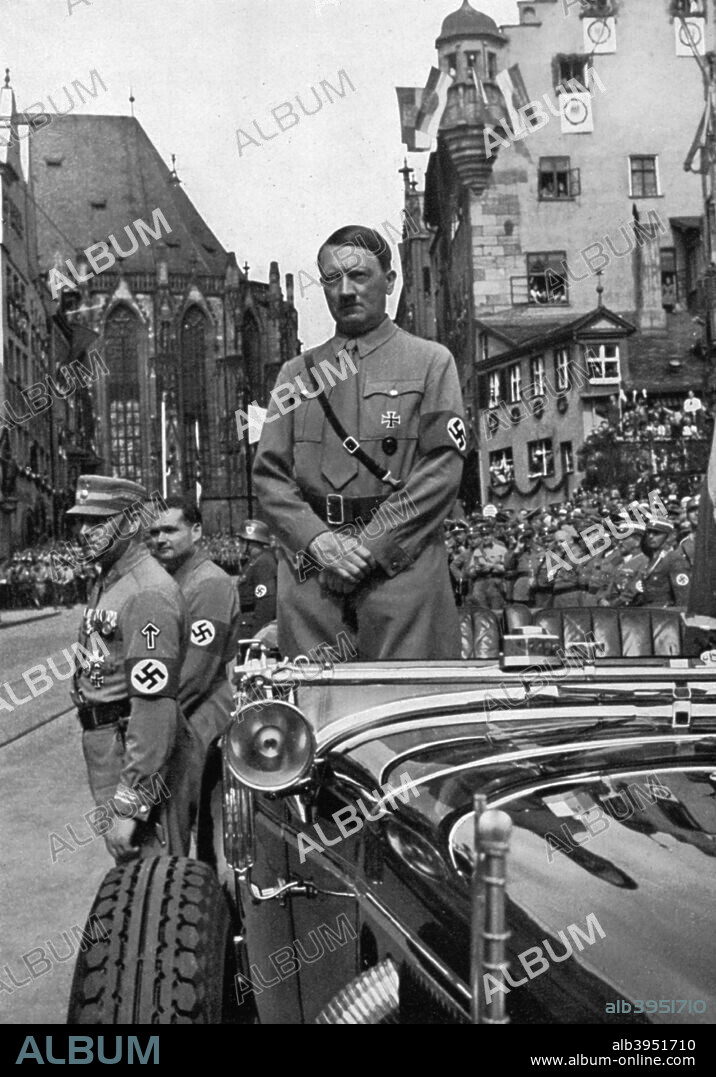 Adolf Hitler waiting for SA 'Brownshirts', Nuremberg, Germany, 1935. Hitler (1889-1945) in Nuremberg for the 7th Party Congress, named the 'Rally of Freedom' by the Nazis. A print from Adolf Hitler. Bilder aus dem Leben des Führers, Hamburg: Cigaretten/Bilderdienst Hamburg/Bahrenfeld, 1936.
