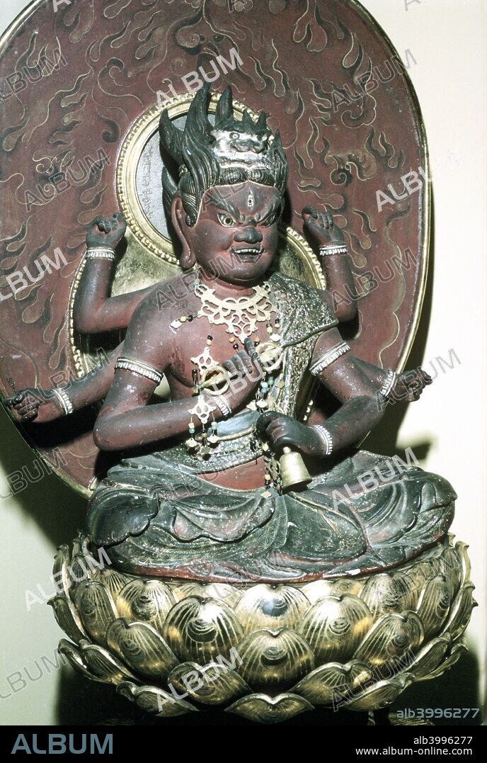 Figure of Aizen Myô-ô, a Buddhist adibuddha, Japanese. Aizen is one of the five Myô-ô (Sanskrit: Vidyarajas), 'Kings of Light', personified spells and protectors of the esoteric Shingon sect of Japanese Buddhism, whose principal deity, Dainichi Nyôrai (Mahavairacana), is the Buddha from whom boundless light emanates. Aizen is usually portrayed wearing a lion-skin hat or wearing a shishi head-dress and he sits on a lotus throne. He has six arms, each holding one of his attributes: bow, arrow, vajras (thunderbolts),.