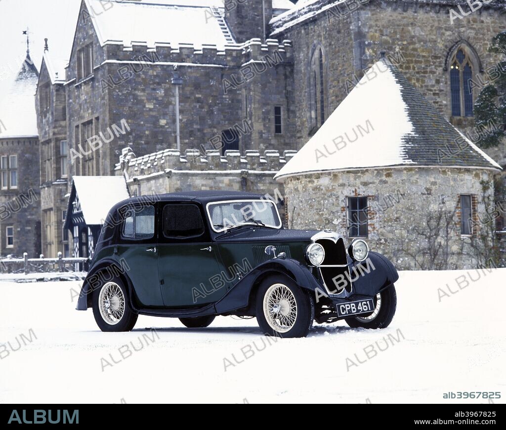 A 1934 Riley Falcon in the snow. This exhibit has the pre-selector gearbox, controlled from the steering wheel. Standard equipment included a sliding roof, opening windscreen and self-cancelling trafficators. By the 1930s, Riley had achieved a well-deserved reputation for advanced design and superb craftsmanship. The Falcon offered plenty of width and headroom yet had the same stylish aero-line of the sporting Kestrel. In 1938, Lord Nuffield bought the Riley company.