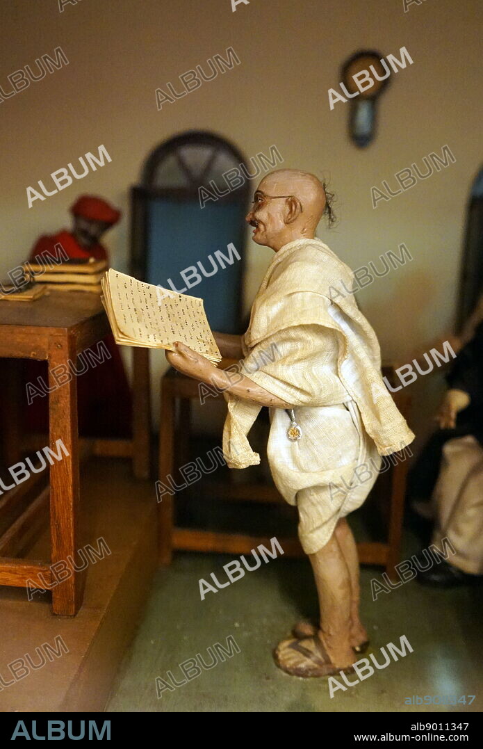 Photograph of a model reconstructing Mahatma Gandhi on trial in 1922. The appeal of "Non-cooperation" grew, its social popularity drew participation from all strata of Indian society. Gandhi was arrested on 10 March 1922, tried for sedition, and sentenced to six years' imprisonment. Mohandas Karamchand Gandhi (1869 1948) was the leader of the Indian independence movement against British rule. Dated 20th Century; 21st Century.
