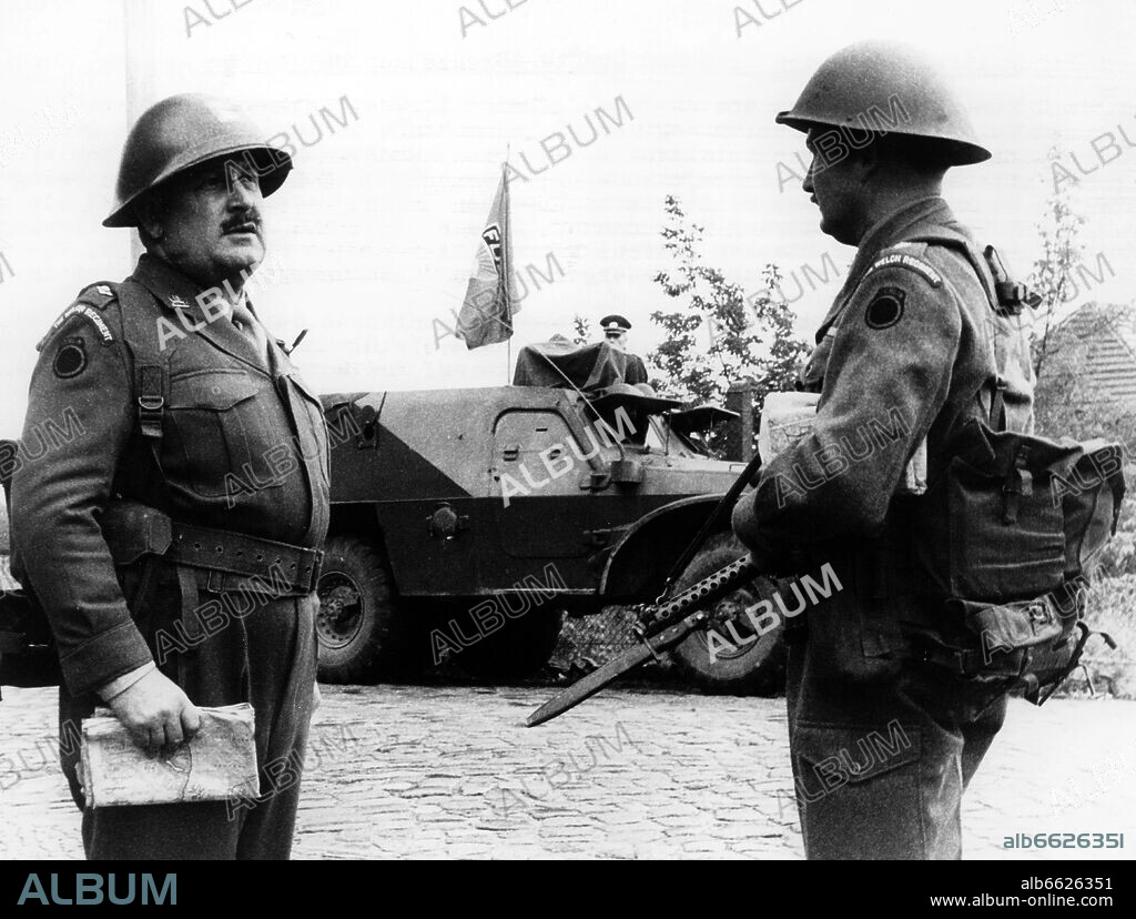 Two soldiers of the British army stand in front of an armoured vehicle from the Soviet zone in Berlin-Spandau on the 21st of August in 1961. 
The border between the Soviet Zone and the British sector of West-Berlin is located directly in the middle of the street, by what Soviet and East German and West German and British police and army stand opposite each other. 21/08/1961
