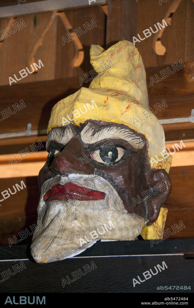 Nang talung' is the shadow puppet theatre popular in southern Thailand. It is an art form said to have originated as early as 400 BC in Southeast Asia. Performances usually last well into the night and remain an essential if diminishing part of village life in Thailand's Deep South. Nang means animal hide, from which the figures are cut. Talung refers to Phatthalung, a town in southern Thailand where the art form is said to have originated.  It is the task of a single skilled person, the 'nai nag' or puppet master, to create the whole show. Sitting behind an illuminated screen, he maneuvers up to six puppets per scene. The changing tone of the puppeteers voice differentiates between the characters, while a band of musicians adds tension to the story. While the more formal 'nang yai' is based on the Hindu epic the Ramayana known as the Ramakien in Thai 'nang talung' takes its inspiration from everyday life.