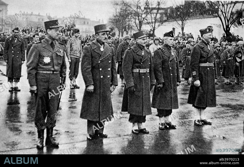 French soldiers being awarded the Legion d'Honneur, Mulhouse, France, 10 February 1945. Troops receiving decorations from General de Gaulle. The soldier on the left of the front row is General Bethouard, commander of the French 1st Army Corps and a Grand Officer in the Legion.