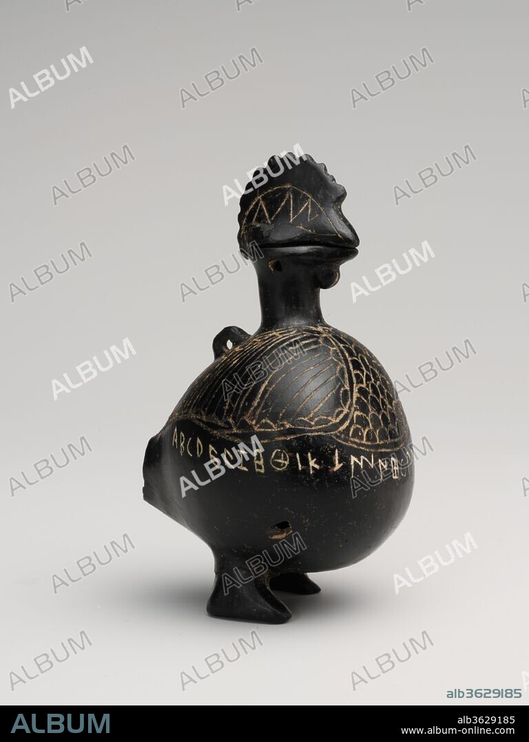 Terracotta vase in the shape of a cockerel. Culture: Etruscan. Dimensions: H. 4 1/16 in. (10.31 cm). Date: ca. 650-600 B.C..
This small vase, inscribed with the twenty-six letters of the Etruscan alphabet, may have been a container for ink. The head acts as a stopper and could be attached to the bird's body by a cord. The missing tail no doubt curved downward to form a third foot.