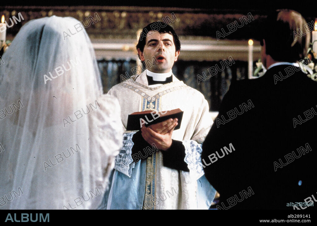 ROWAN ATKINSON in FOUR WEDDINGS AND A FUNERAL, 1994, directed by MIKE NEWELL. Copyright GRAMERCY PICTURES.