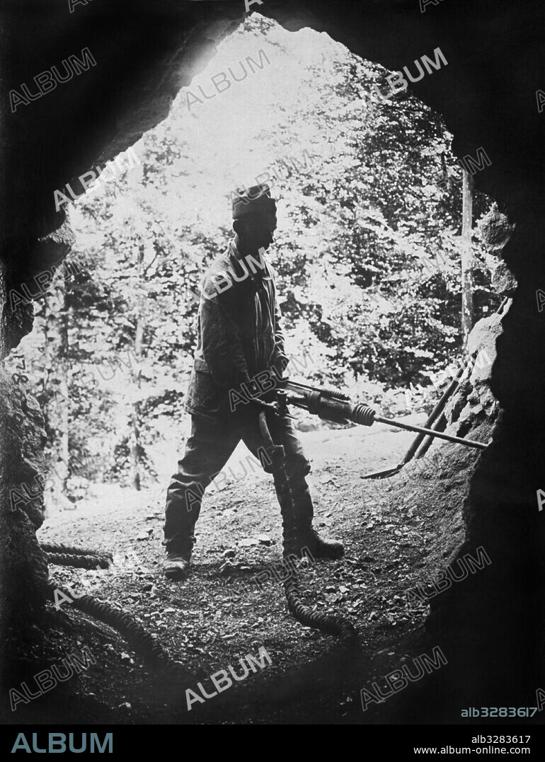 Switzerland:  July 23, 1918 A Swiss Army soldier working on tunnels and dug outs in the mountains. They are always working to maintain their armed neutrality status.