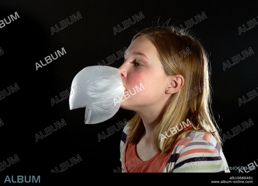 A young girl blowing and popping a bubble gum bubble. This image is part of a series. The action was captured with the use of high speed flash.