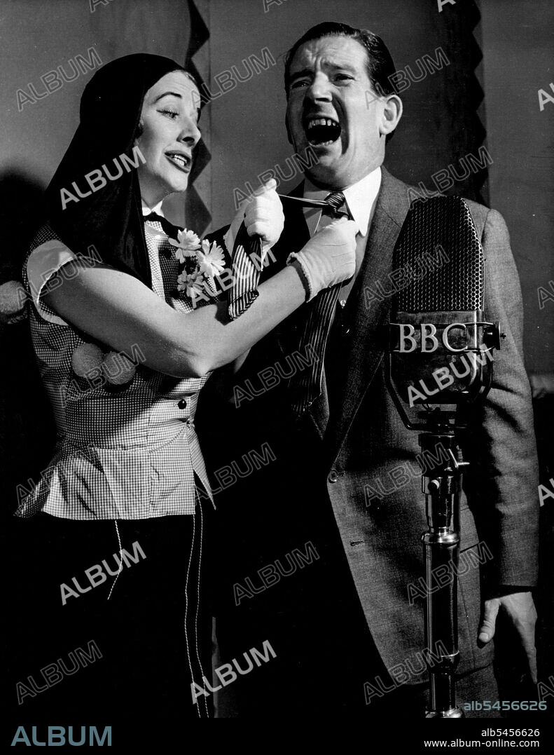 "Ray's A Laugh" broadcast weekly in the BBC Home Service.Kitty fixes Ted's tie in no uncertain manner. Ted Ray and Kitty Bluett (who plays the part of Ted's wife). November 15, 1951.