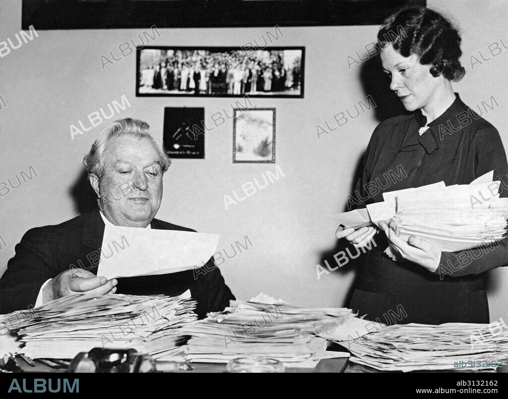 Washington, D.C.:   1935 Senator Pat McCarran of Nevada and his assistant Hazel Smith sort through the avalnche of letters supporting his action of  inserting the prevailing wage clause in the four billion dollar relief bill.