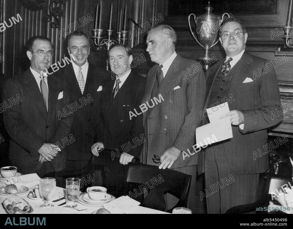 At American Australian Association Lunch -- Percy C. Spender, New Australian Ambassador to the United States (center) is guest of honor at a luncheon at the University Club, New York City, June 11, Given by the American Australian Association. Left to right: John D. Hickerson, Assistant Secretary of State, Myron M. Cowen, U.S. Ambassador to the Philippines and former Ambassador to Australia; Ambassador Spender; Sir Keith Murdoch, President of the Australian American Association and publisher of the Melbourne Herald and Mr. Edward E. Robbins, President of the American Australian Association. November 6, 1951. (Photo by Associated Press Photo).