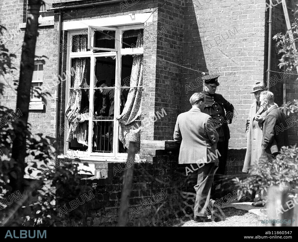 Bomb sent to Capt Farran kills his brother . A parcel bomb enclosed ina copy of Shakespeare's plays , and intended for Captain Roy Farran , whom the Palestine Stern gang threatened a year ago to " follow to the end of the world " , today killed his 26-year-old brother Rex Farran , when he opened the parcel at this home at Codsall , near Wolverhampton . The parcel had been posted in Britain . The explosion wrecked the room and blew out all the windows. Mr Farran was rushed to hospital with multiple injuries , but he died less than two hours after being admitted . Picture shows Mr Farran (father) extreme right , talks to Police offricers in the garden of his house at Histon's Hill ,. Codsall near Wolverhampton , after the explosion in the dining room , which resulted in the death of his son Rex . The dining room is seen with windows blown out . 3 May 1948.
