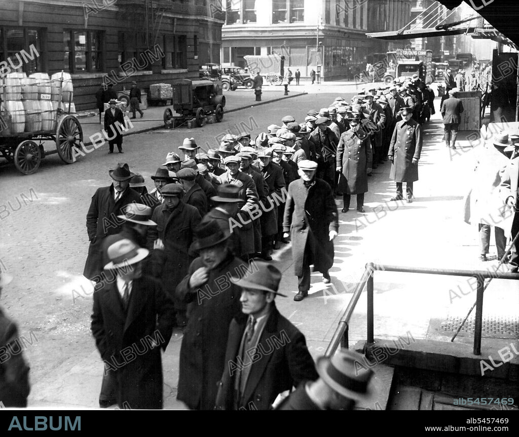 Bread Line For Unemployed -- The long line of Jobless men, mostly well-dressed union members, which formed at 27 east 4th. Street where they received bread and soup for one cent. This kitchen is maintained by the international labor relief, which is attempting to help unionized laborers. March 28, 1928. (Photo by International Newsreel Photo).