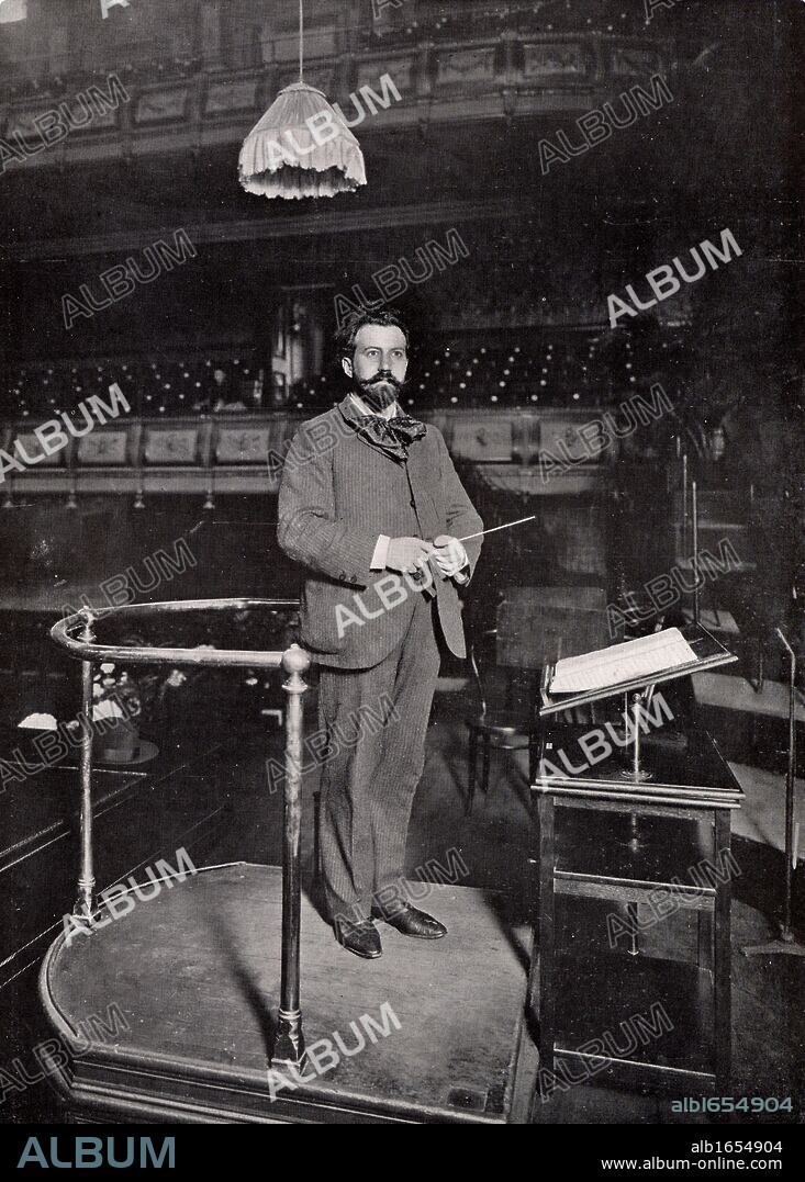 Henry Joseph Wood (1869-1944) English conductor. Wood on the conductor's podium at the Queen's Hall, London, in 1903. In 1895 he took charge of the Promenade concerts at Queen's Hall and continued in this role for the next 50 years. After the destruction of Queen's Hall in the London blitz in 1941 the season of Promenade concerts transferred to the Royal Albert Hall, Kensington, where they still continue. (Photo by: Universal History Archive/UIG via Getty Images).