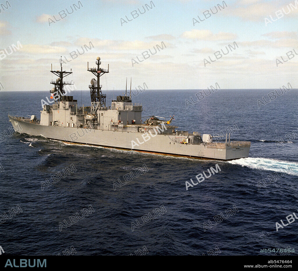 1976 - A port quarter view of the destroyer USS PAUL F. FOSTER (DD 964) underway off the coast of Southern California.  A Light Helicopter Anti-submarine Squadron 33 (HSL-33) SH-2F Seasprite helicopter can be seen aboard the ship.