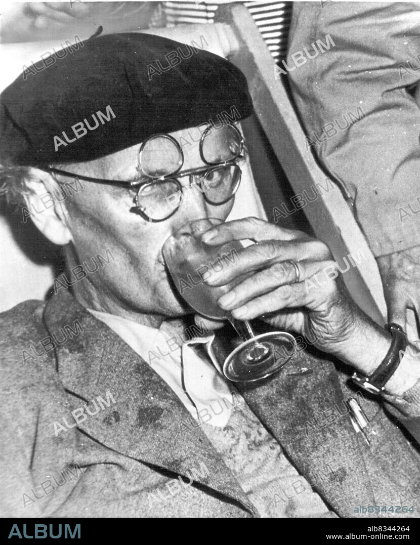 More Water For Piccard -- Prof. Auguste Piccard, Swiss-born scientist, sips a glass of water after his record dive of 10,330 feet to the bottom of the Tyrrheanian Sea off the island of Ponza, September 30. Piccard and his son Jacques rode their odd diving boat, the Trieste, to the bottom as two Italian naval corvettes stood by after one of them had towed the diving boat into position. October 04, 1953. (Photo by AP Wirephoto).