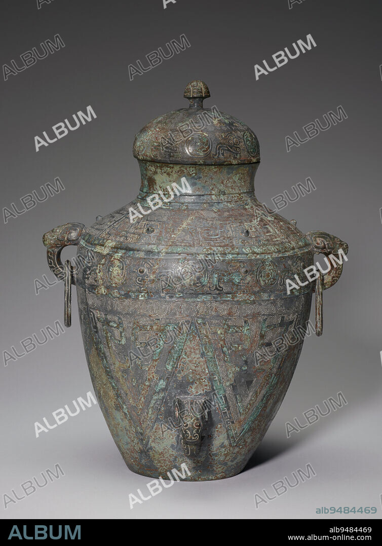Lei' wine vessel, 1300-1201 BCE, 14 5/16 × 11 3/16 × 9 1/8 (Diam: 8 7/8 in.; Weight: 11.7 lb.) (36.35 × 28.42 × 23.18 × 22.54 cm, 5.3 kg) (overall), Bronze, China, 13th-12th century BCE, Used for holding wine and sometimes water, this piece represents a category of vessels in which a typical pottery shape has been translated into bronze. New technology accommodated precise decorative schemesthinner vessel walls and more structurally sound knobs, handles, and pendant ringsthan was possible in pottery. As bronze artisans continued to perfect their craft, vessels became increasingly elaborate, intricately cast, and varied in form.