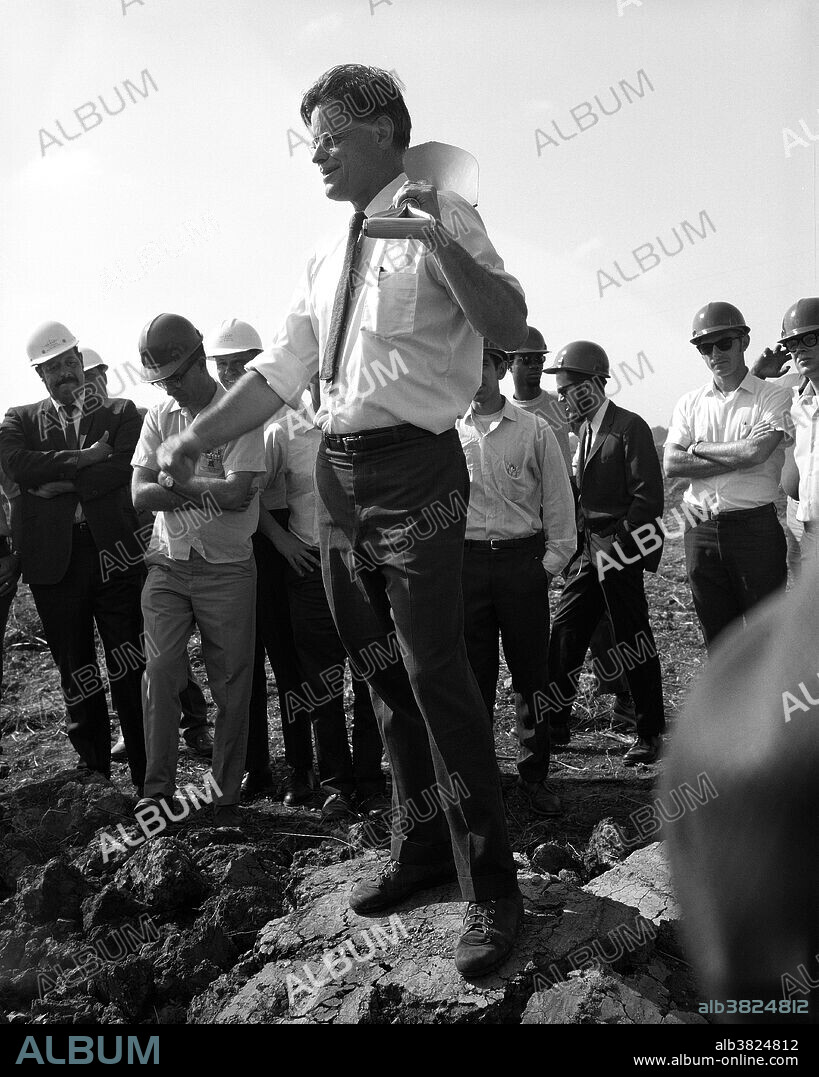 Wilson at the groundbreaking for Fermilab's Main Ring accelerator in 1969. Robert Rathbun Wilson (March 4, 1914 - January 16, 2000) was an American physicist who was a group leader of the Manhattan Project, a sculptor, and an architect of Fermi National Laboratory (Fermilab), where he was also the director from 1967-1978. In 1943, Wilson was appointed as head of the Cyclotron Group (R-1) by Oppenheimer for the Manhattan Project at Los Alamos. Only in his late twenties, he was the youngest group leader in the experimental division. After the bombings of Hiroshima and Nagasaki, Wilson helped organize the Association of Los Alamos Scientists (ALAS), which called, with a scientists' petition, for the international control of atomic energy. He also helped form the Federation of American Scientists and served as its chairman in 1946. In 1967 he took a leave of absence from Cornell to assume directorship of the not-yet-created National Accelerator Laboratory. Under Wilson's leadership the facility was completed on time and under budget. Originally named the National Accelerator Laboratory, it was renamed the Fermi National Accelerator Laboratory (Fermilab for short) in 1974. Wilson served as the director of Fermilab until 1978, and then joined the faculty of the University of Chicago. In 1982 he became Michael I. Pupin Professor of Physics at Columbia University. He retired in 1984 and died in 2000, at the age of 85, after a prolonged illness.