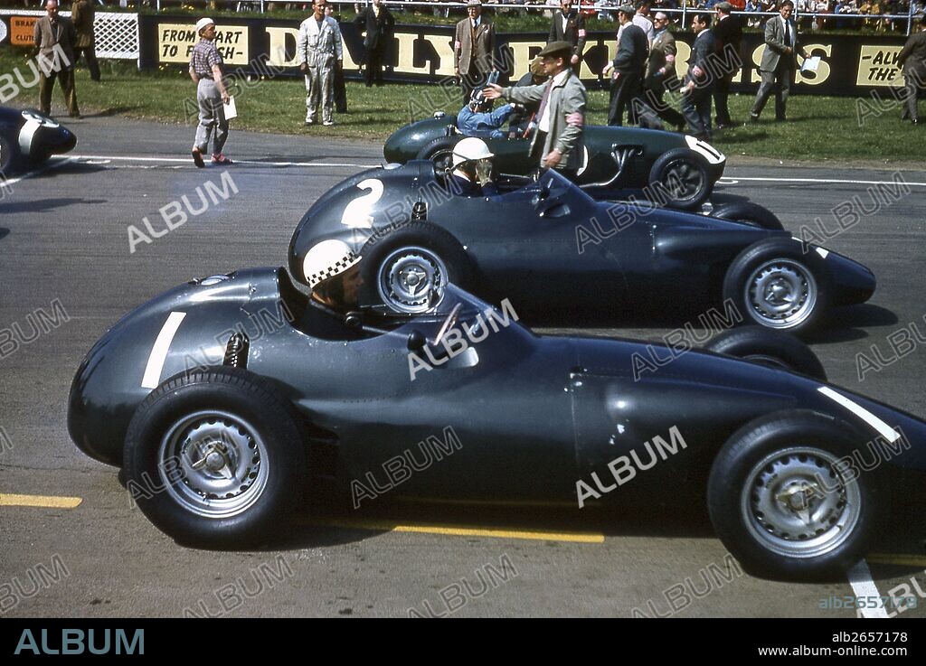 Jean Behra on pole in his BRM Type 25 with Harry Schell in the sister BRM and Graham Hill Lotus-Climax Type 12 on outside. BRDC International Trophy at Silverstone, England 1957.