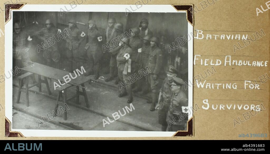 Photograph - Batavian Medical Workers Waiting for Survivors, Batavia, World War II, 1941-1942, Black and white photograph from a photography album by David Ralph Goodwin, RAN. The album contains 108 black and white photographs from World War II, many highly significant, showing sea battles (live fire), survivors, wounded and the dead being buried at sea. The photographs are secured with photo corners - a few now adrift. Includes images of German troops evacuating from Greece; German.