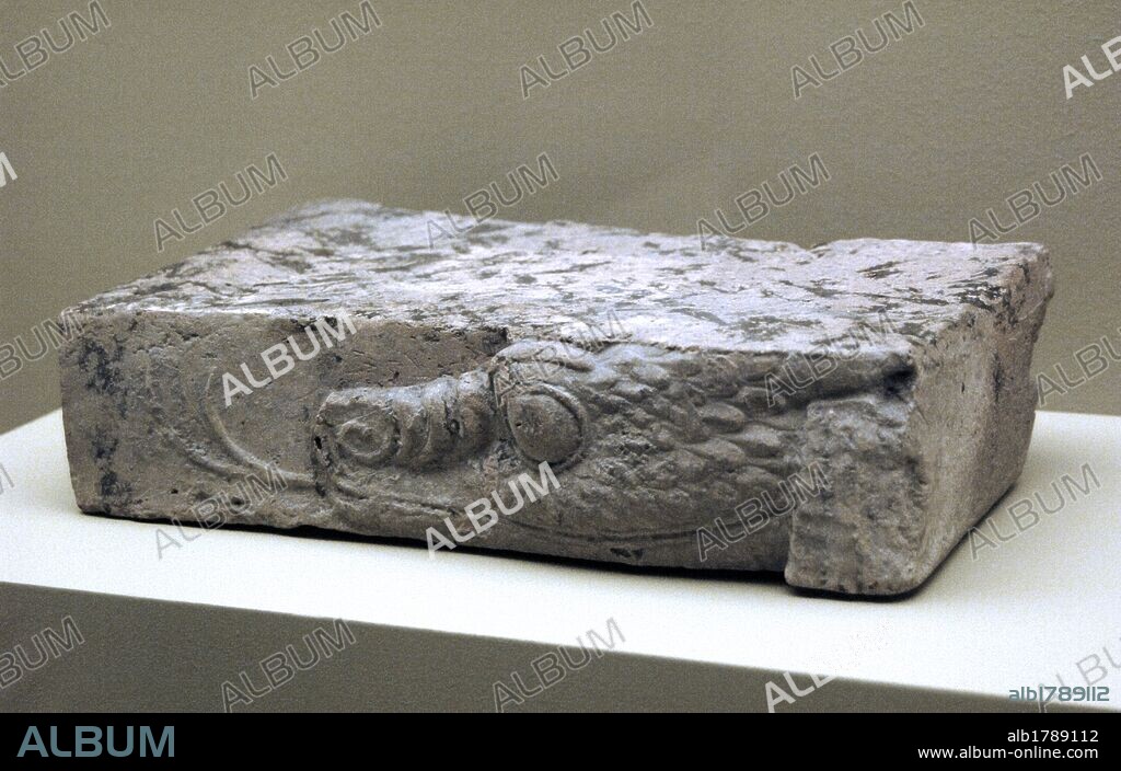 Fragment of baked clay brick, moulded and unglazed, with a mushussu-dragon's head in relief. Reign of Nebuchadnezzar II (630-562 BC). Neo-Babylonian Empire or Chaldean Empire. Louvre Museum. Paris, France.
