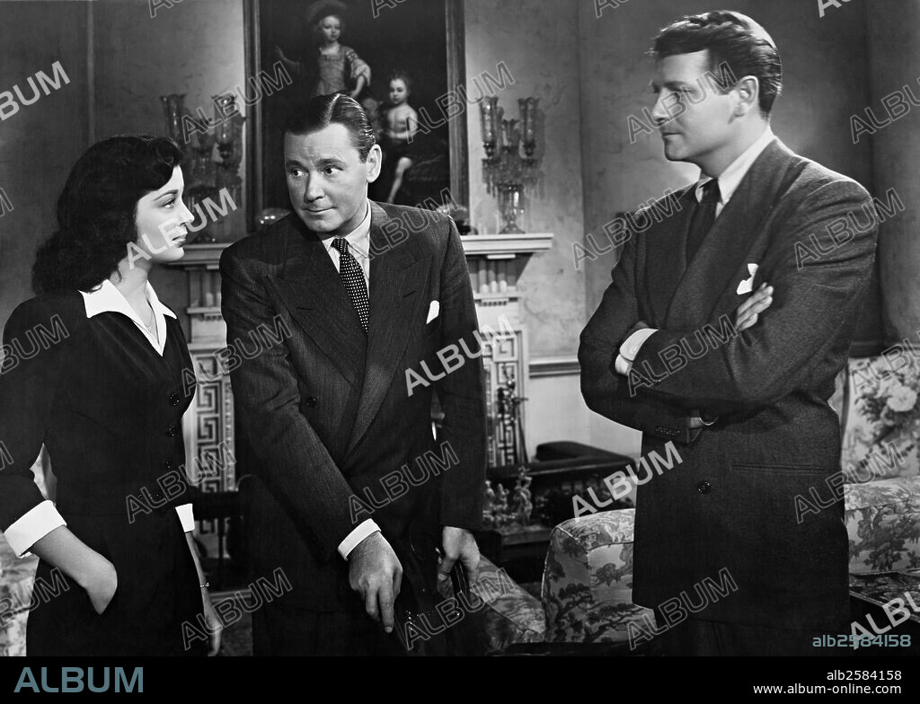GAIL RUSSELL, HERBERT MARSHALL and JOEL MCCREA in THE UNSEEN, 1945, directed by LEWIS ALLEN. Copyright PARAMOUNT PICTURES.