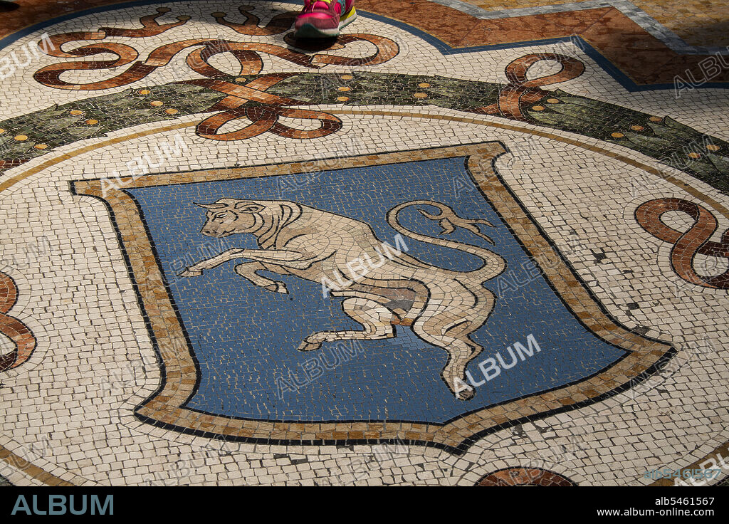 Milan, Lombardy, Italy, Europe. Duomo Square, Galleria Vittorio Emanuele II. The mosaic of the bull in the center of the gallery.