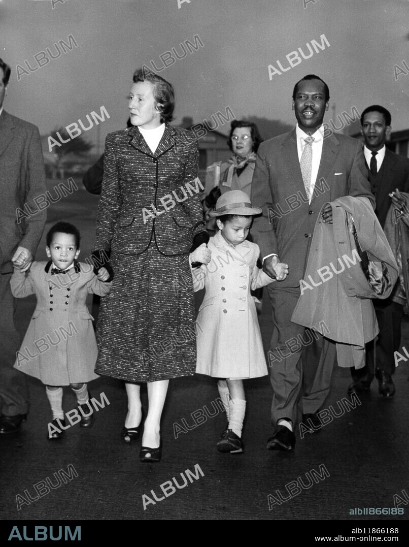 Seretse Khama on the way home. Seretse Khama, the exiled former cheif of the Bamangwato tribe, arrives at London Airport today with his wife Ruth and children Jacqueline and Ian. He was on the way back to Bechuanaland, after renouncing his claim to the chieftainship, at the end of his exile, started in 1950 when his marriage to Ruth Williams caused a split in his tribe. His flight from London Airport to Salisbury, Southern Rhodesia, today was delayed by fog. He is to be joined by his wife and children at Serowe at the end of the month. 9 October 1956.