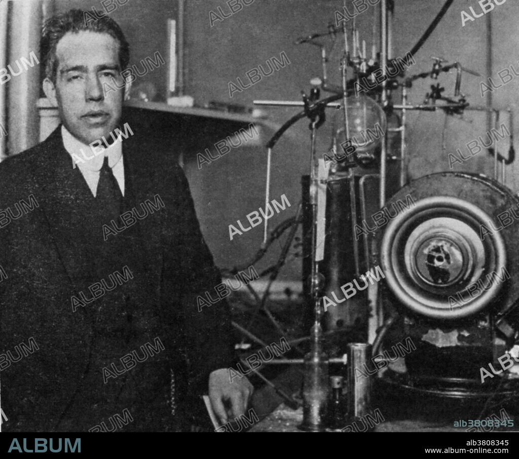 Bohr beside a magnet and gas-discharge apparatus he used to study the properties of atoms in gases, 1922. Niels Henrik David Bohr (October 7, 1885 - November 18, 1962) was a Danish physicist who made foundational contributions to understanding atomic structure and quantum mechanics, for which he received the Nobel Prize in Physics in 1922. Bohr published his model of atomic structure in 1913 wherein he introduced the theory of electrons traveling in orbits around the atom's nucleus, the chemical properties of each element being largely determined by the number of electrons in the outer orbits of its atoms. He also introduced the idea that an electron could drop from a higher-energy orbit to a lower one, in the process emitting a photon (light quantum) of discrete energy. This became a basis for quantum theory. Bohr mentored and collaborated with many of the top physicists of the century at his institute in Copenhagen. He was part of the British team of physicists working on the Manhattan Project where he was known by the name of Nicholas Baker for security reasons. His role on the project was as consultant. Following the war Bohr returned to Copenhagen where he died in 1962 of heart failure.
