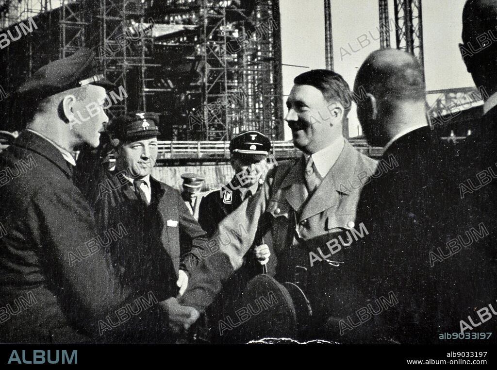 Adolf Hitler visits the Blohm & Voss the shipbuilding and engineering works. The company built aircraft through Hamburger Flugzeugbau before and during World War II. Germany's rearmament in violation of the Versailles Treaty meant a big change in fortune for the company, run then by brothers Rudolf and Walther Blohm, which was taken out of a deep crisis. From July 1944 to April 1945 the company used inmates of its own concentration sub camp at its shipyard in Hamburg-Steinwerder, a sub camp of Neuengamme concentration camp.