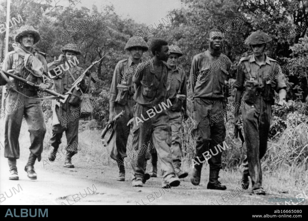 CAPTURED KATANGAN GUERILLAS. Elisabethville, Katanga, Congo, Africa : With hands behind their backs, two captured Katangan guerillas are escorted by Indian United Nations troops after they had been captured during the UN forces advance into Jadotville. Jadotville, Katangan President Moise Tshombe's stronghold, was captured yesterday without resistance. Mercenaries had been expected to make a stand in the town, but according to local people they left at 10am, after first carrying out acts of sabotage. 4 January 1963.
