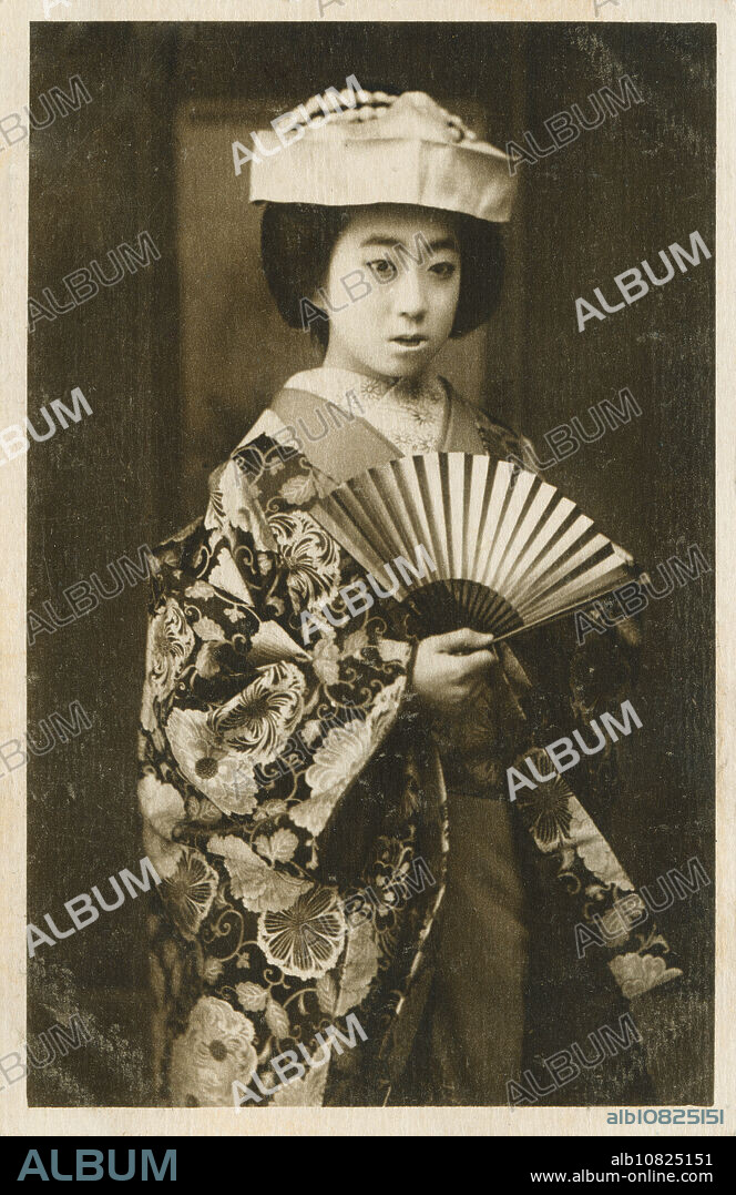 [ 1910s Japan - Portrait of a Japanese Bride ] Portrait of a bride holding a sensu fan and wearing a wedding kimono and tsunokakushi, headwear that hides the brides horns of jealousy, ego and selfishness. Tsunokakushi symbolizes the brides resolve to become a gentle and obedient wife. 20th century vintage postcard.