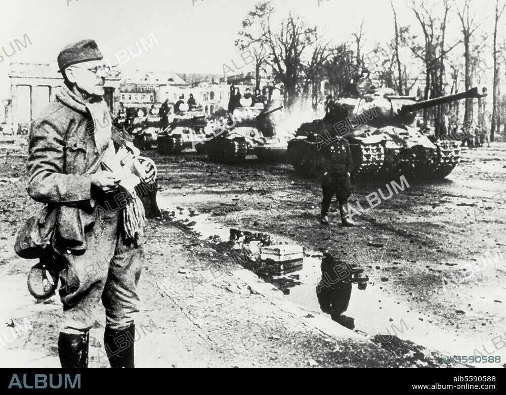 Berlin, May 1945. World War II / End of the War. Soviet tanks on Charlottenburger Chaussee. A released "Volkssturm" member in the foreground. Photo, Yevgeny Khaldei.