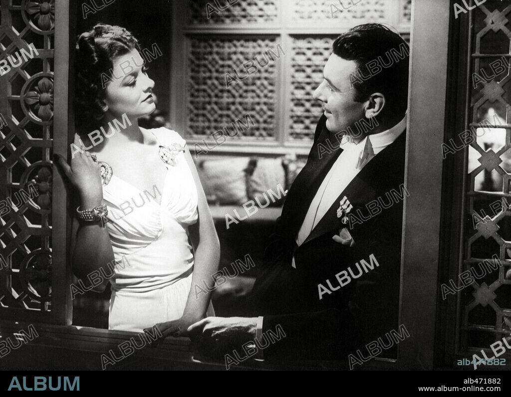 GEORGE BRENT and MYRNA LOY in THE RAINS CAME, 1939, directed by CLARENCE BROWN. Copyright 20TH CENTURY FOX.
