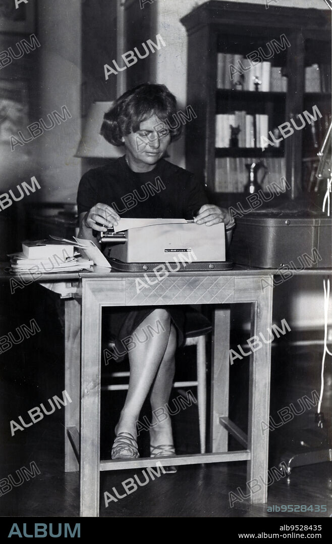 The Italian writer Elsa Morante, sitting at the desk of her studio, writes something with a typewriter. Italy, 1976 (Credit Image: © Monadori Portfolio/Mondadori Portfolio via ZUMA Press).