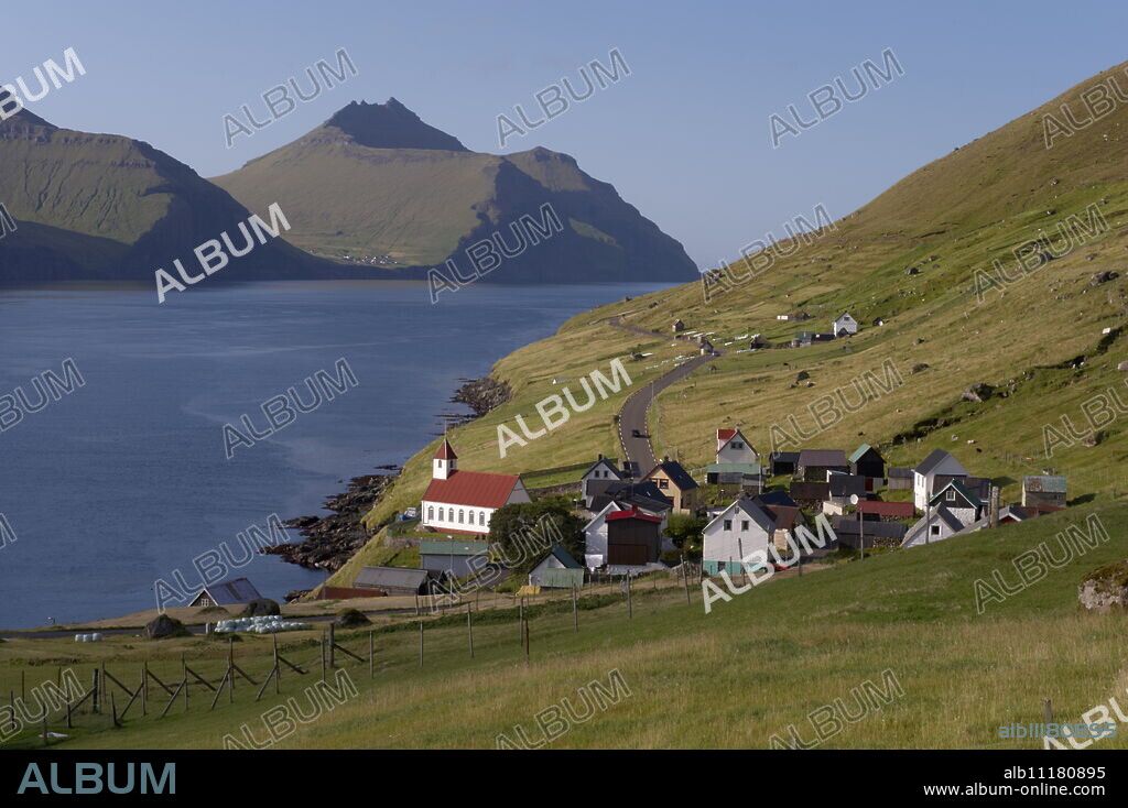 Village of Kunoy, located on the west coast of the island Kunoy, impressively surrounded by high mountains, Kunoy Island, Nordoyar, Faroe Islands (Faroes), Denmark, Europe.